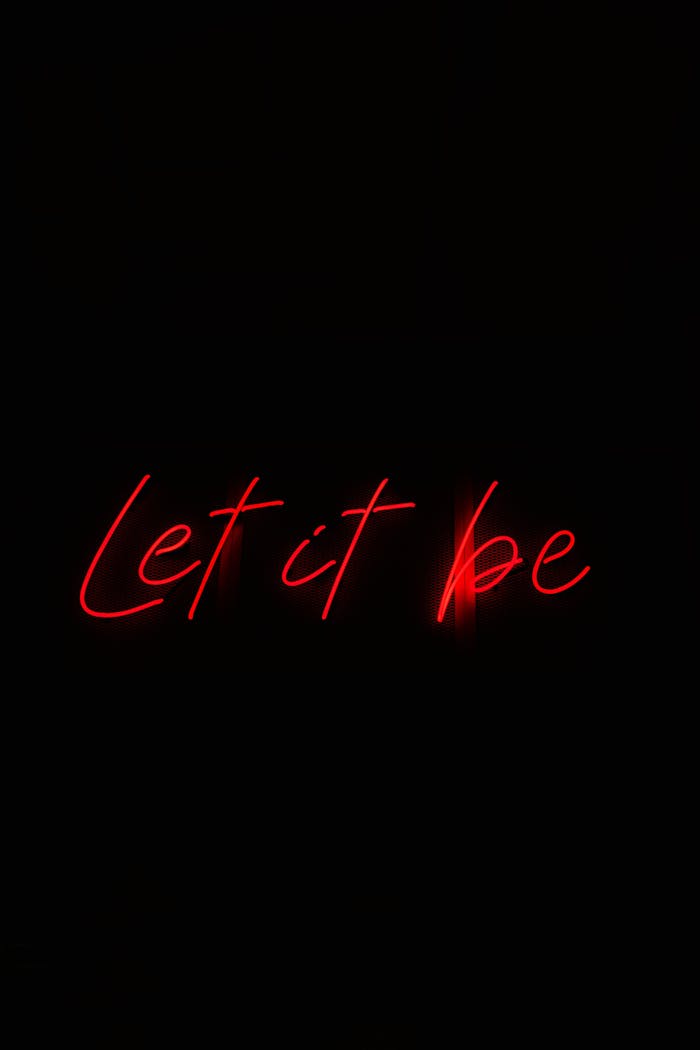 services-04 Red neon text 'Let it be' glowing against a dark black background.